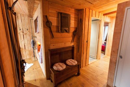 a hallway in a log cabin with wooden walls at Le Passage in Ax-les-Thermes