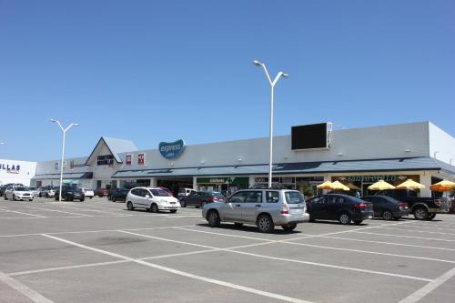 a parking lot with cars parked in front of a store at Depto Maitencillo frente al Mar - Costamai in Maitencillo