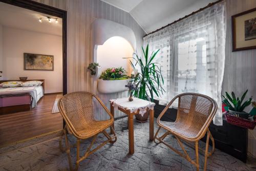 a room with two chairs and a table and a bed at Sunny Apartment Sofia in Sofia