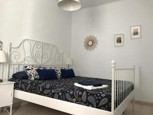 a bedroom with a white bed with blue pillows at PureLight Marbella in Marbella