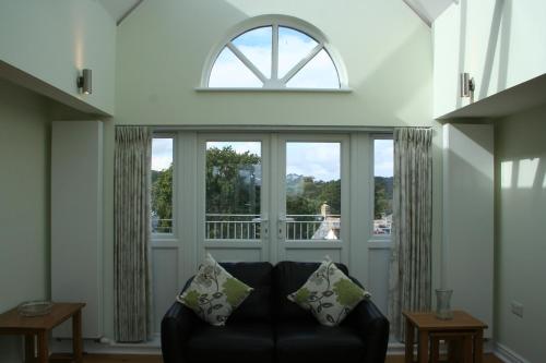 a living room with a couch and a window at Highlands Apartment 4 in Shanklin
