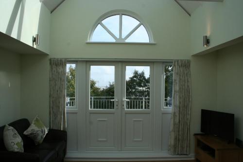 a living room with a door and a window at Highlands Apartment 4 in Shanklin