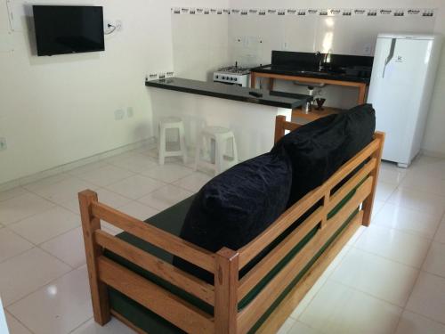 a couch with black pillows sitting in a kitchen at Recanto das Geraes in Arraial d'Ajuda