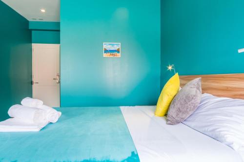 a room with a bed with colorful pillows on it at Bed & Bike Curacao in Willemstad