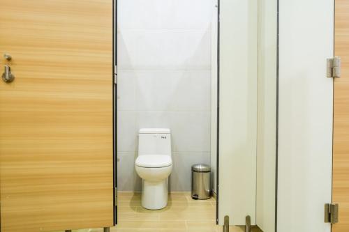 a bathroom with a toilet through a door at Bed & Bike Curacao in Willemstad