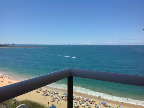 a view of a beach with a crowd of people at Flat Na Praia da Costa in Vila Velha