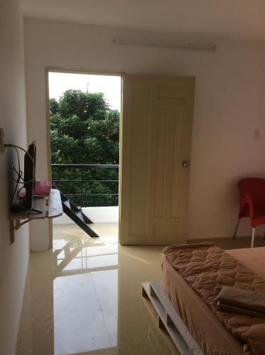 a bedroom with a bed and a door to a balcony at Lan Thai Ngoc Hotel in Cao Lãnh