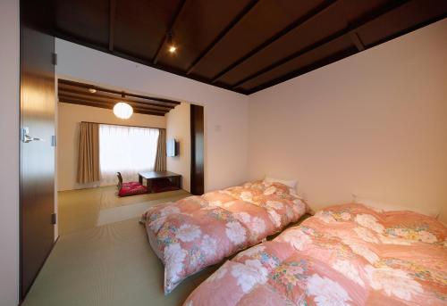 um quarto com 2 camas e uma janela em Miyabi Cosy House em Quioto