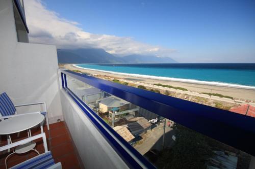 a view of the beach from the balcony of a hotel at Hotel Bayview in Dahan