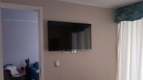 a flat screen tv hanging on a wall at Edificio One in Iquique