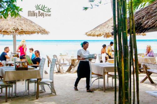 A restaurant or other place to eat at Milky Bay Resort