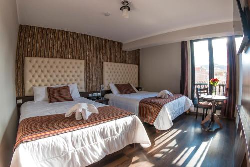 Ureta Hotel tesisinde bir odada yatak veya yataklar