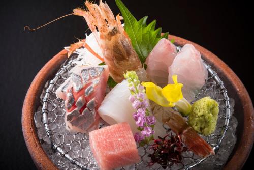 a plate of food with meat and vegetables on it at Ryotei Manyou in Nomi