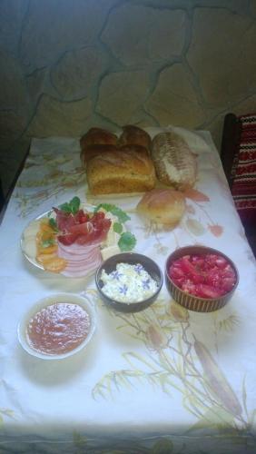 a table topped with different types of bread and other foods at Amigówka in Wieliczka