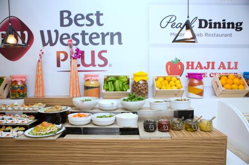 a buffet with fruits and vegetables and other foods at Best Western Plus Pearl Creek in Dubai