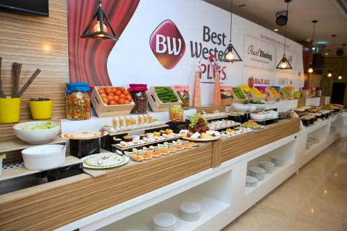 a buffet line with food on display in a store at Best Western Plus Pearl Creek in Dubai