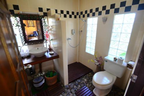a bathroom with a shower and a toilet and a sink at Viang Yonok Hotel, Restaurant, Sports Club in Chiang Saen