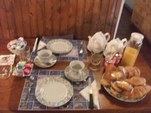 a table with plates of food and drinks on it at Grotto Pergola in Giornico
