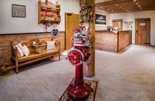 a store with a red machine in the middle of a room at Appartementhaus Speckalm in Katschberghöhe