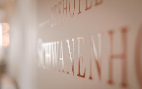 a white wall with red writing on it at Seehotel Schwanenhof in Mölln