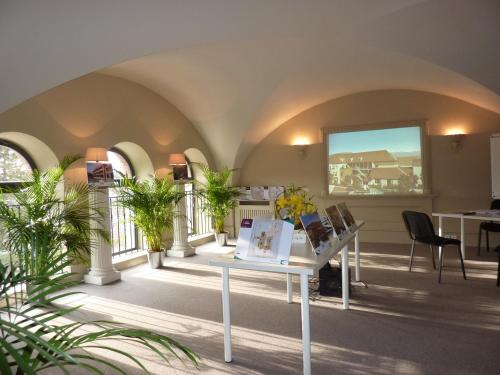 a room with a table and some plants at Hôtel Restaurant Spa Le Sauvage in Besançon