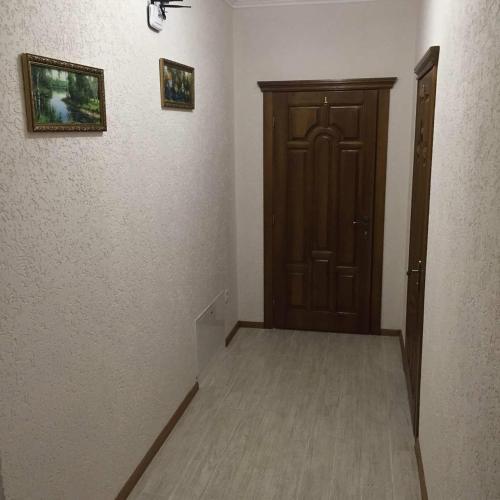 a room with a door and a hallway with a wooden door at Polyana Apart in Polyana