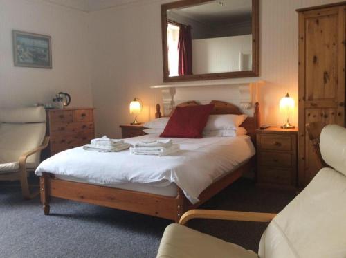 a bedroom with a large bed with a mirror on it at Cavell House Bed and Breakfast in Clevedon