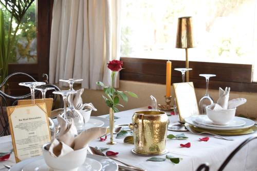 a table with a white table cloth with white dishes on it at Riad Abracadabra in Marrakech