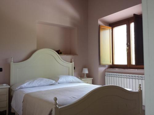 PreturoにあるAzienda Agrituristica Tenuta ValViola Amiternumのベッドルーム(白いベッド1台、窓付)