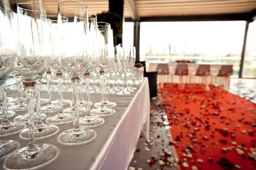 a row of wine glasses sitting on a table at Hotel City Maribor in Maribor