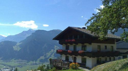 a house on a hill with a view of mountains at Saibatenhof in Hainzenberg