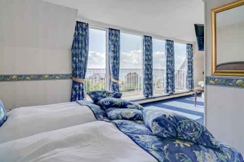 En eller flere senge i et værelse på Hotel Sønderborg Garni