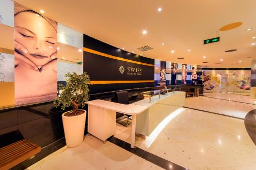 a hair salon with a large advertisement on the wall at Hotel Grand Swiss in Erbil