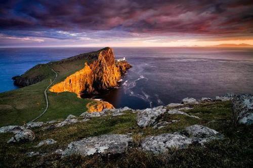 a view of a cliff in the ocean at sunset at Heaste Retreat in Broadford