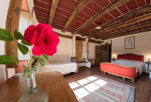 a vase with a flower on a table in a room at B&B Esprit d'un Moment in Nolay