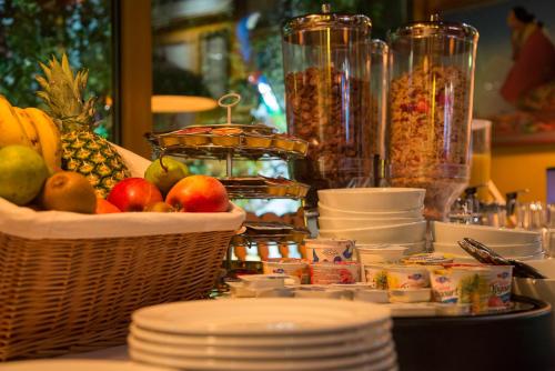 a table topped with baskets of fruit and other food at Hotel California in Zürich
