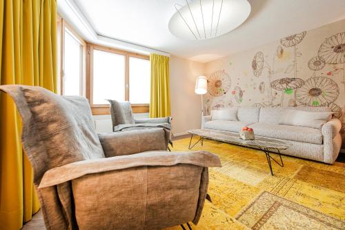 a living room with a couch and a table at Wellness Hotel Stoos in Stoos