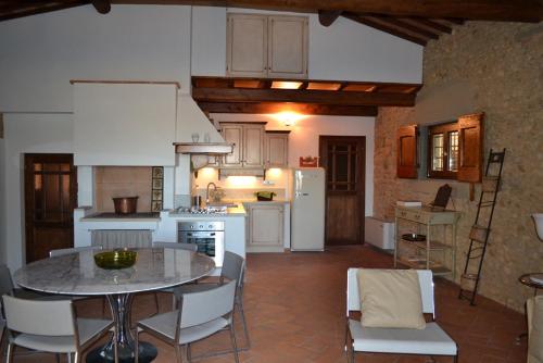 a kitchen with a table and a kitchen with white appliances at Charming Self House in San Casciano in Val di Pesa