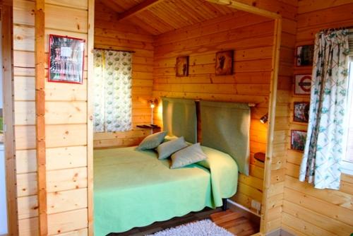 a bedroom in a log cabin with a bed at Etna Hut in Nicolosi