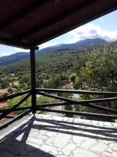 a view of the mountains from the porch of a house at Stonehouse 2 Bedroom Chalet on Olympus Amazing View in Pétra
