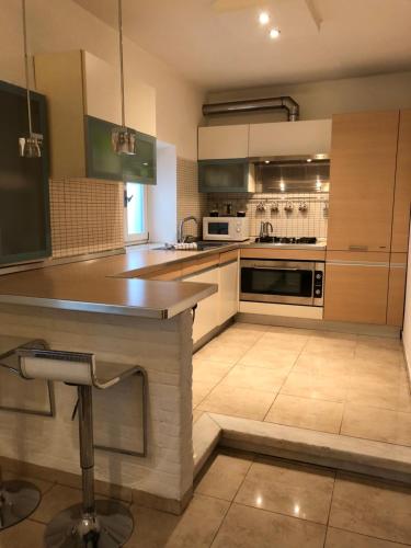 a kitchen with stainless steel appliances and a counter at La Porta Nel Giardino in Asti