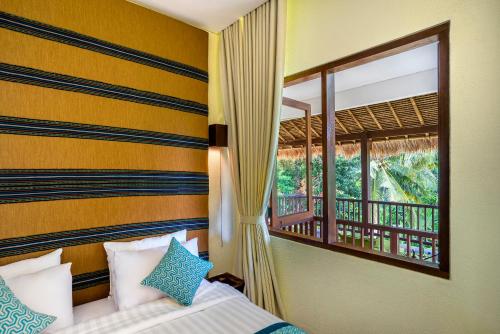 Ein Bett oder Betten in einem Zimmer der Unterkunft Rumah Suweta