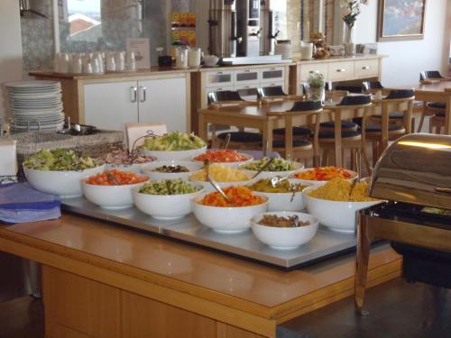 a buffet with bowls of food on a table at STF Malmfältens Folkhögskola in Kiruna