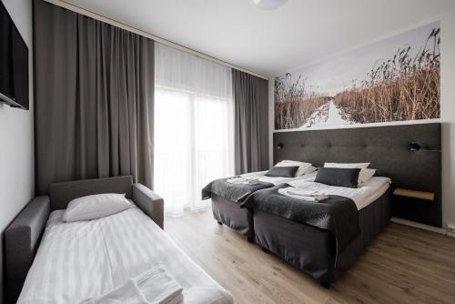 Ένα ή περισσότερα κρεβάτια σε δωμάτιο στο Forenom Aparthotel Kempele