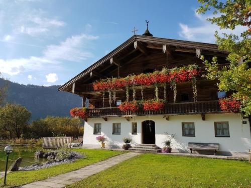 a house with flower boxes on the side of it at Golf- und Sporthotel Moarhof in Walchsee