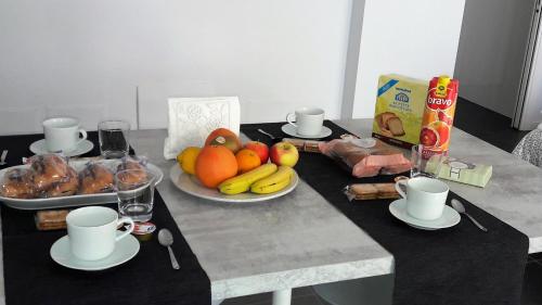 a table with a bunch of fruits and food on it at Casa Battisti in Pero