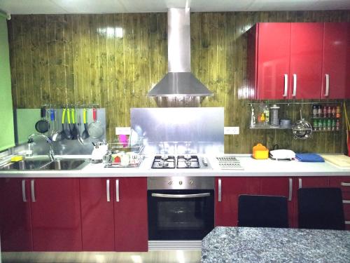 a kitchen with a stove top oven and a sink at Pensión Universal in Valencia