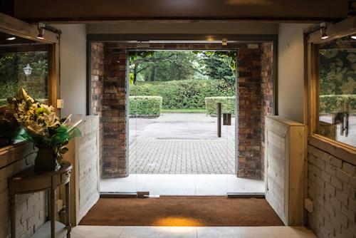an open door to a room with a patio at The Punchbowl Lapworth in Solihull
