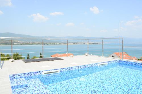 a swimming pool with a blue sky and blue water at Apartments Exclusive Palace in Trogir