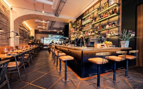 a restaurant with a bar with stools at ION City Hotel, Reykjavik, a Member of Design Hotels in Reykjavík